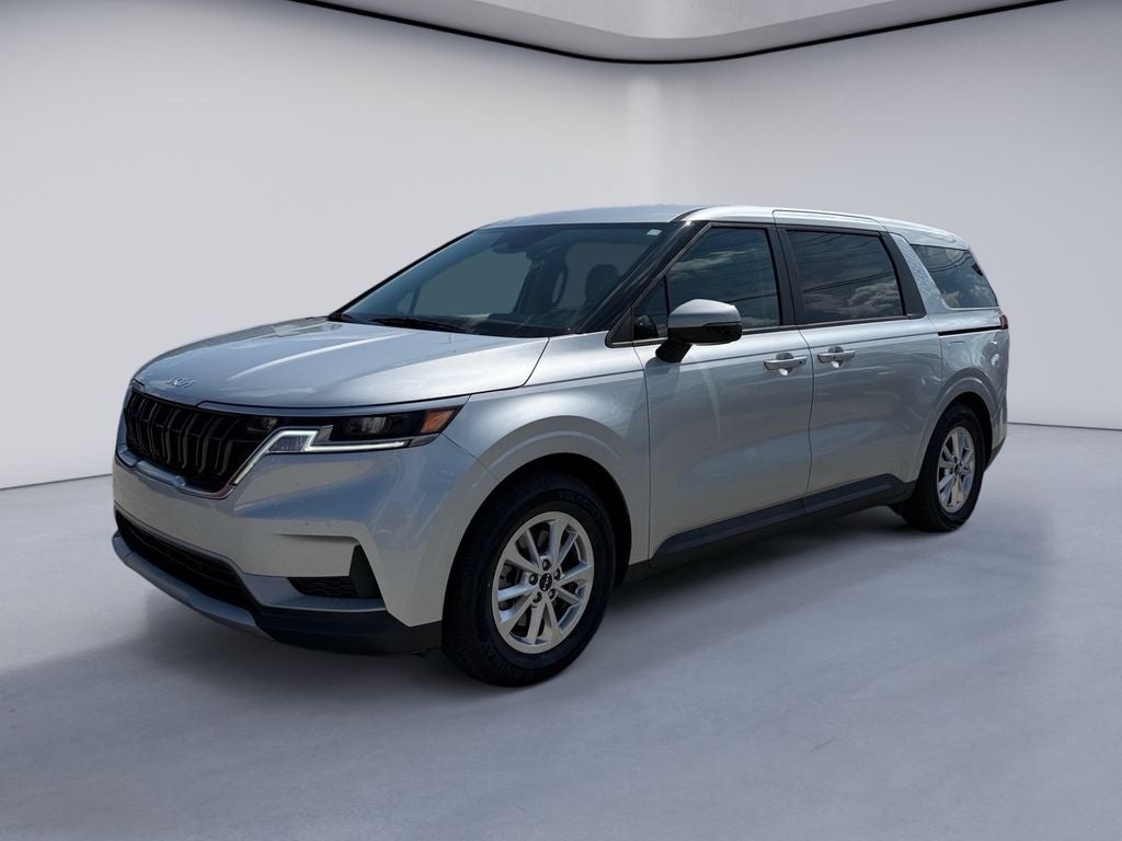2023 Kia Carnival LX in Silky Silver — front three-quarter view